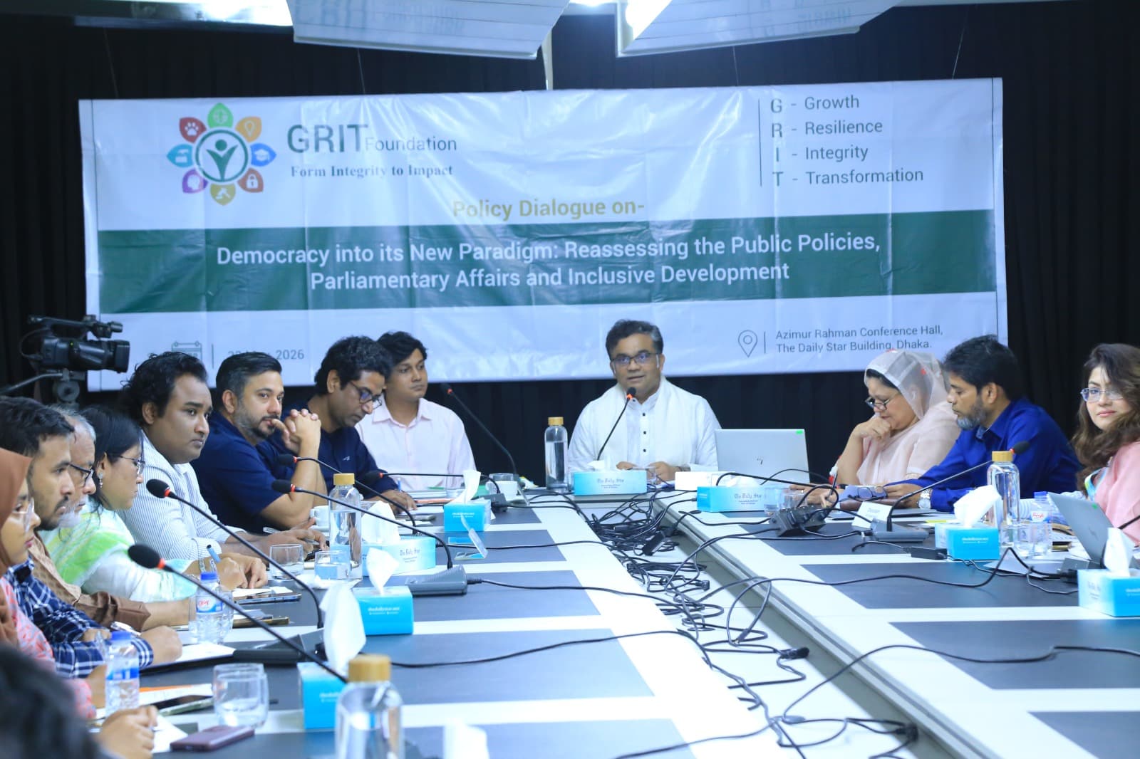 GRIT team members in a civic dialogue session, seated in a circle and speaking to one another